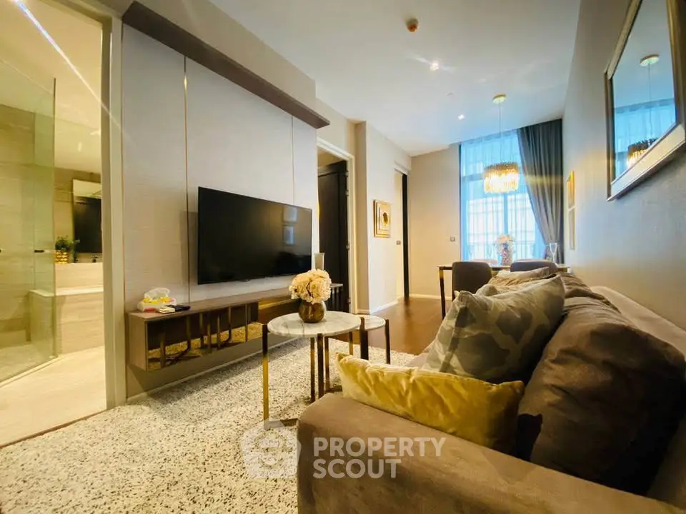 Luxurious modern living room with elegant decor and large TV, perfect for relaxation and entertainment.
