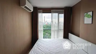 Modern bedroom with city view and air conditioning in high-rise apartment