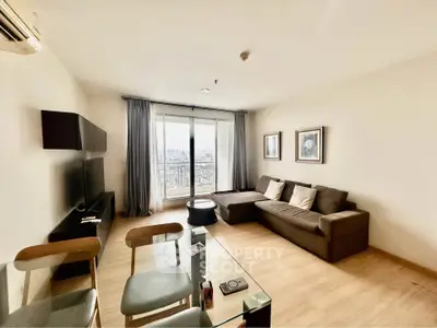 Spacious modern living room with city view, stylish furniture, and natural light.