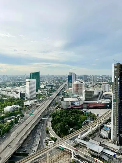 Stunning cityscape view showcasing modern skyscrapers and expansive highway network under a clear sky.
