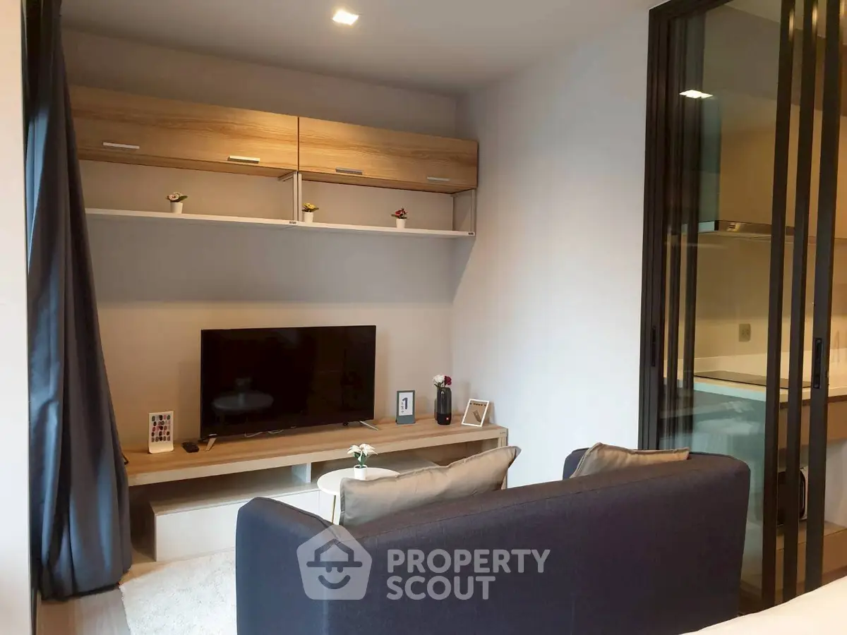 Modern living room with sleek TV setup and cozy seating area