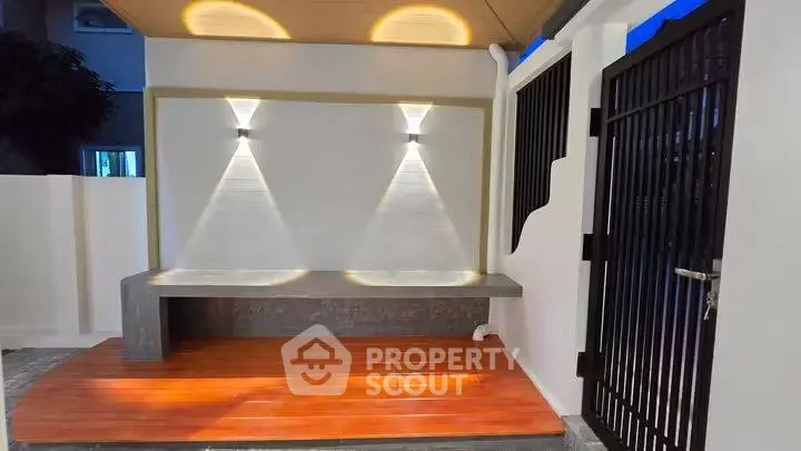 Modern outdoor entrance with stylish lighting and wooden deck