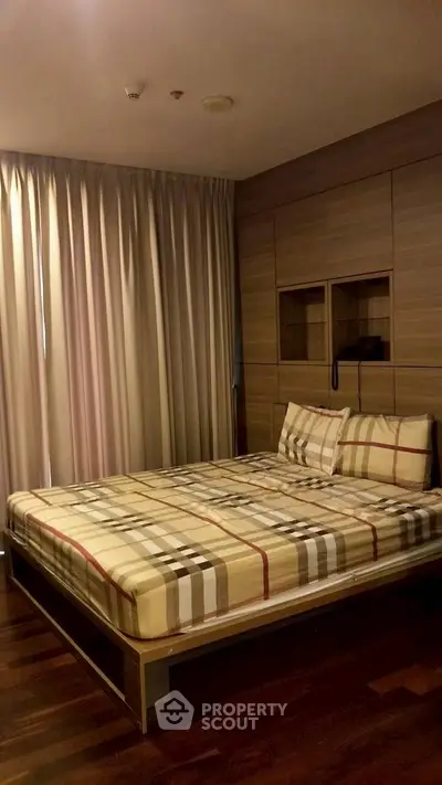 Cozy bedroom with stylish wooden accents and elegant curtains