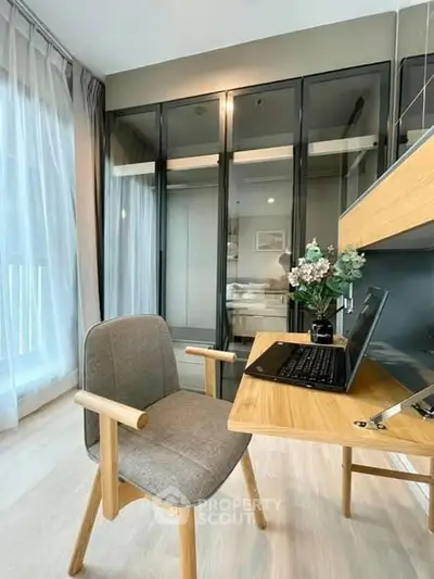 Modern study room with sleek glass wardrobe and stylish desk setup