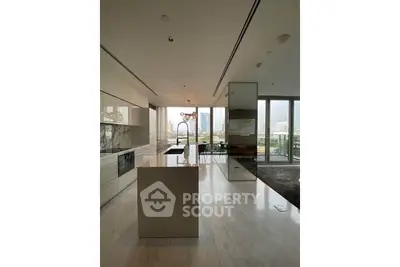 Luxurious modern kitchen with open layout and stunning city view, featuring sleek cabinetry and elegant design.
