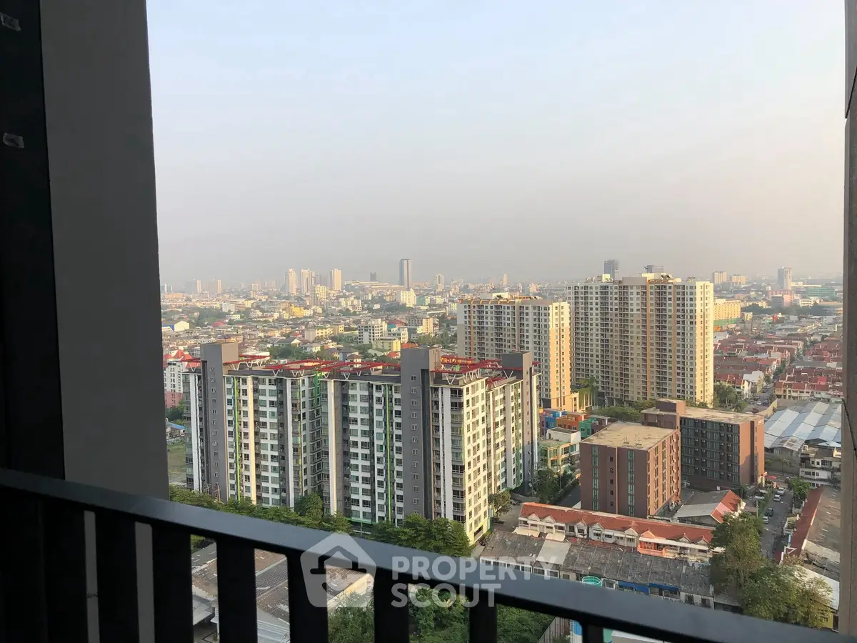 Stunning cityscape view from high-rise balcony overlooking urban skyline.