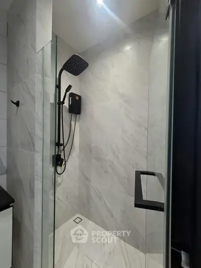Modern bathroom with sleek shower design and elegant marble tiles