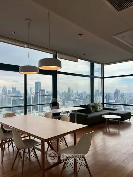 Stunning high-rise living room with panoramic city views and modern furnishings.