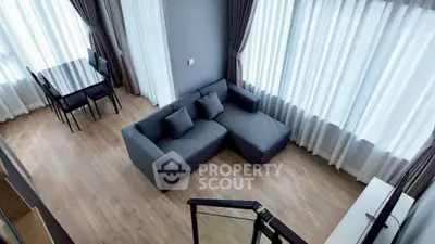 Spacious modern living room with large windows and stylish furniture