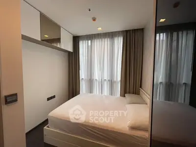 Modern bedroom with large windows and minimalist design in a stylish apartment.