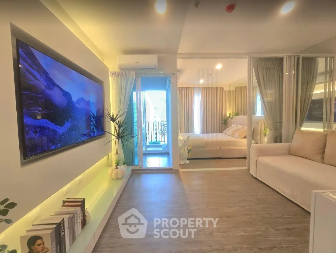 Modern open-plan living room with stylish decor and balcony view in a contemporary apartment.