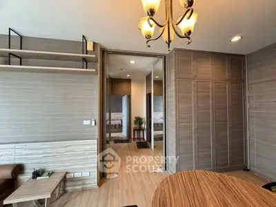 Modern interior with wooden accents and elegant chandelier in a cozy living space.