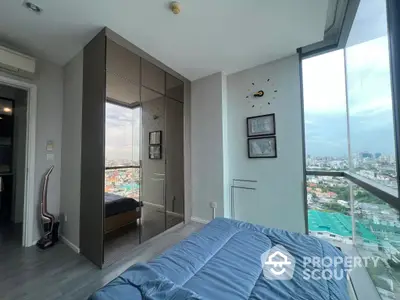 Modern high-rise bedroom with floor-to-ceiling windows offering panoramic city views, mirrored wardrobe, and contemporary decor.