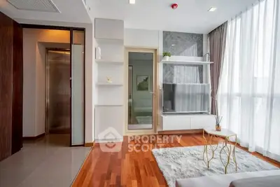 Modern living room with hardwood floors, large windows, and stylish decor in a high-rise apartment.