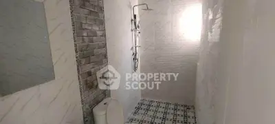 Modern bathroom with stylish shower and tiled walls