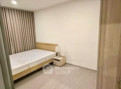 Modern minimalist bedroom with wooden bed frame and neutral decor