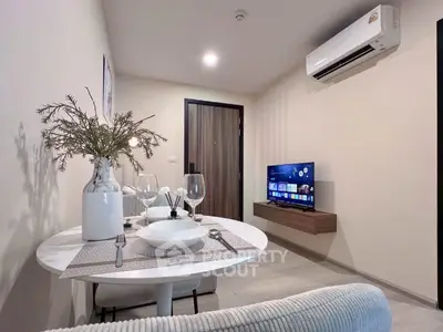 Modern living room with dining area, featuring sleek furniture and wall-mounted TV, perfect for cozy living.