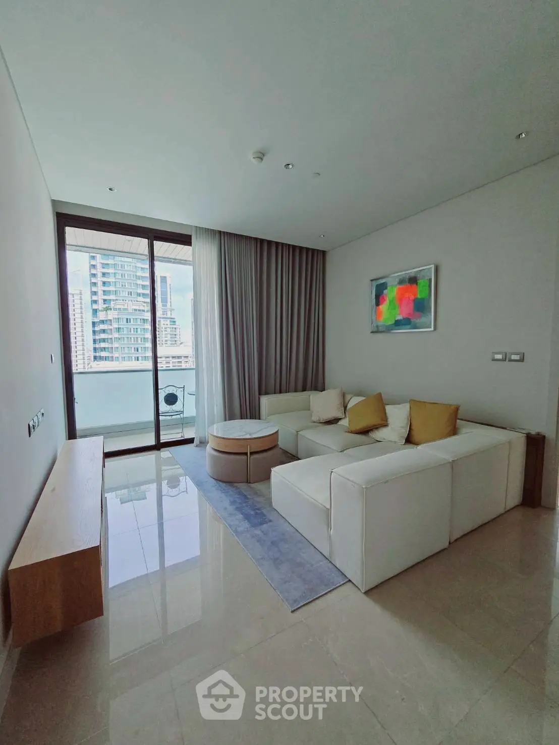 Modern living room with sleek design and city view balcony in luxury apartment.