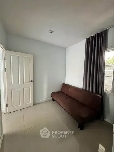 Cozy room with a brown sofa and elegant curtains, perfect for relaxation.