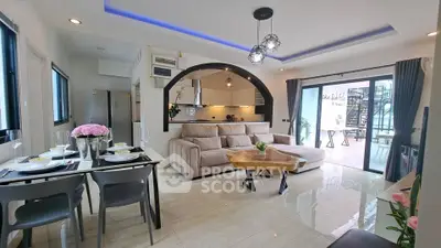 Modern open-plan living room with stylish kitchen and cozy seating area