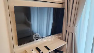 Modern living room with sleek wall-mounted TV and elegant curtains