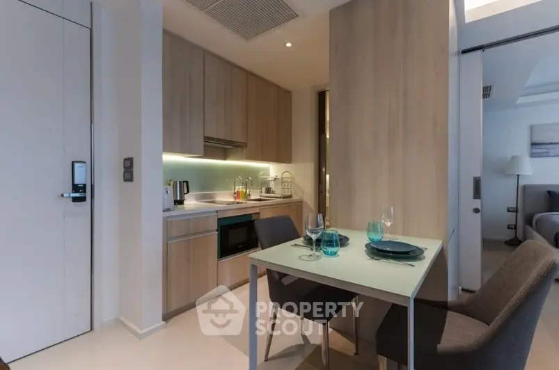 Modern compact kitchen with dining area in stylish apartment
