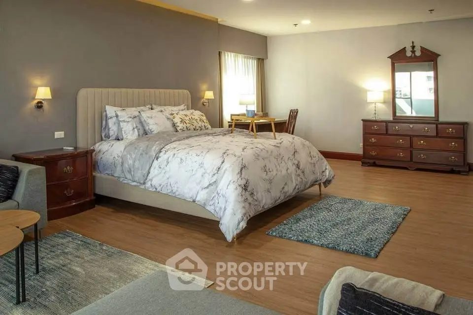 Spacious bedroom with elegant decor and natural light