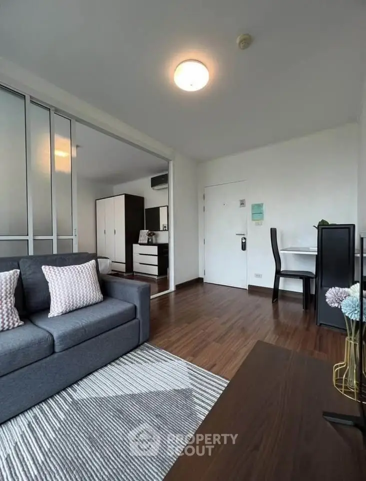 Modern living room with sleek furniture and wooden flooring