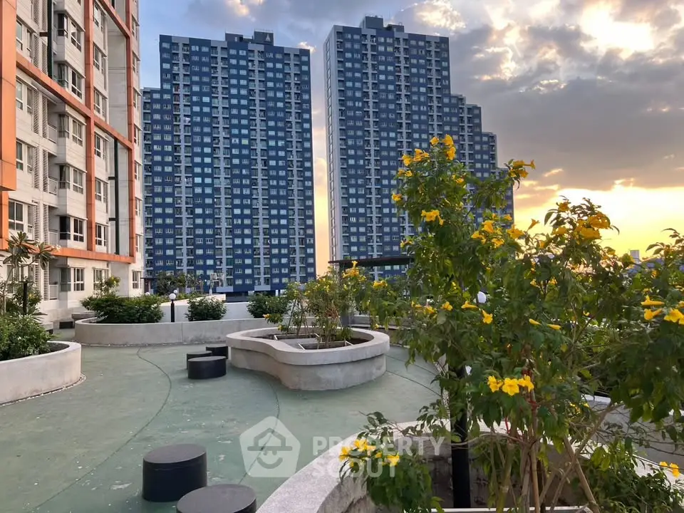 Stunning rooftop garden with city skyline view at sunset, perfect for relaxation and leisure.