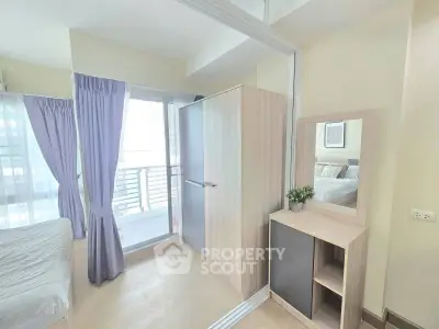 Bright bedroom with balcony access and modern furniture in a stylish apartment.