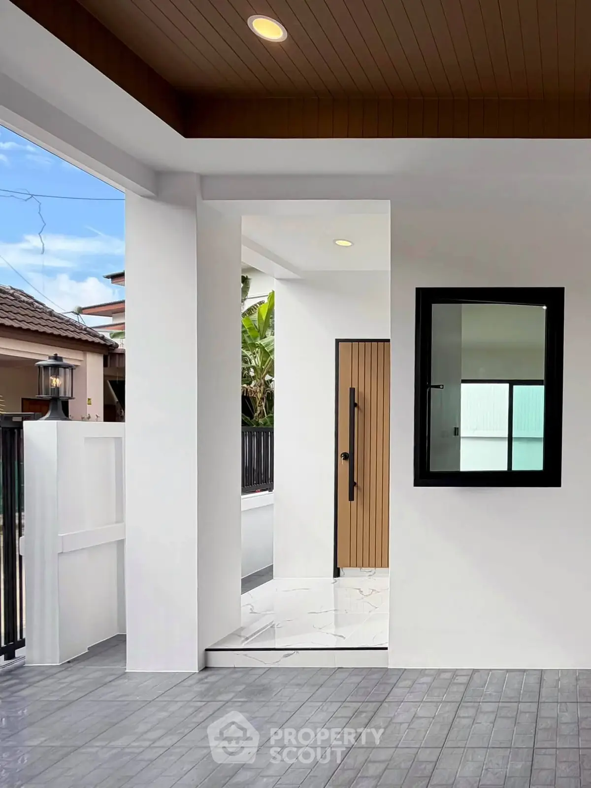 Modern house entrance with sleek design and wooden accents, showcasing contemporary architecture and inviting ambiance.