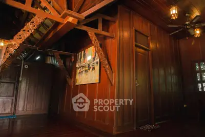 Charming wooden interior with intricate carvings and warm lighting, perfect for a cozy living space.