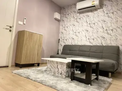 Modern living room with stylish marble accent wall and cozy gray sofa