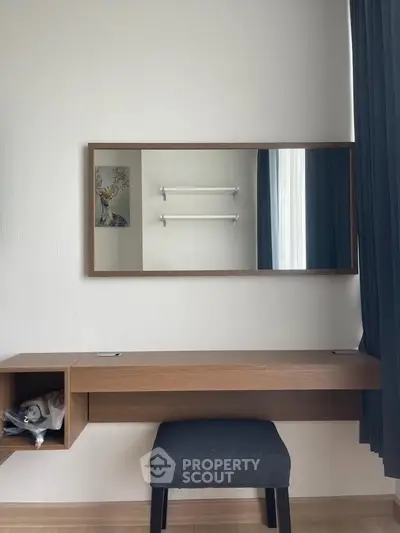 Modern study area with sleek wooden desk and mirror, perfect for productivity.