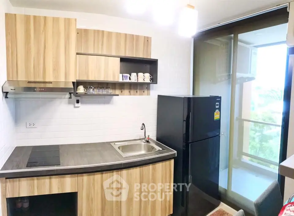 Modern kitchen with sleek wooden cabinets and balcony view
