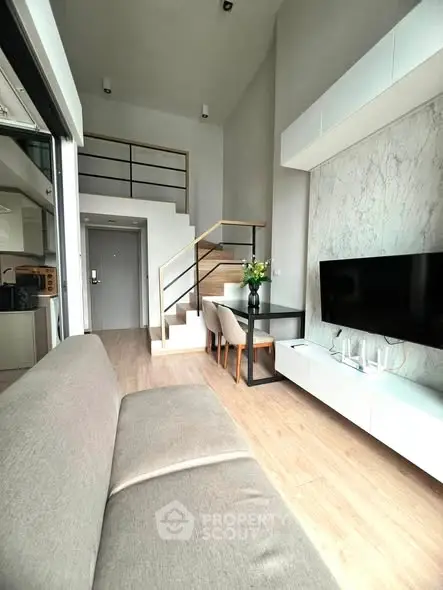 Modern loft-style living room with high ceilings and elegant decor