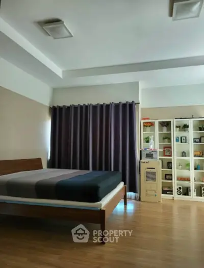Spacious bedroom with modern decor and ample natural light