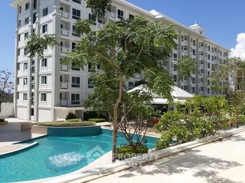 Luxurious condominium with stunning pool and lush greenery, perfect for modern living.