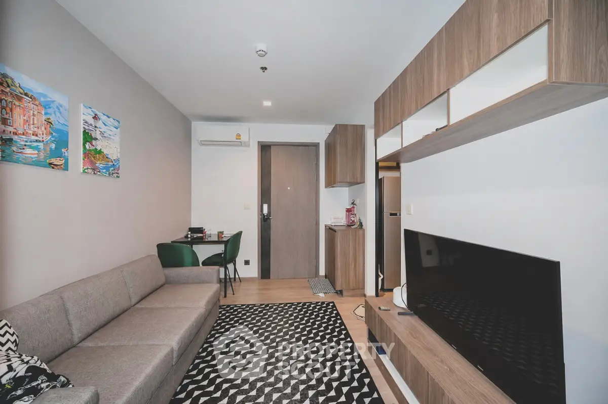 Modern living room with stylish decor, cozy sofa, and sleek entertainment unit in a contemporary apartment.