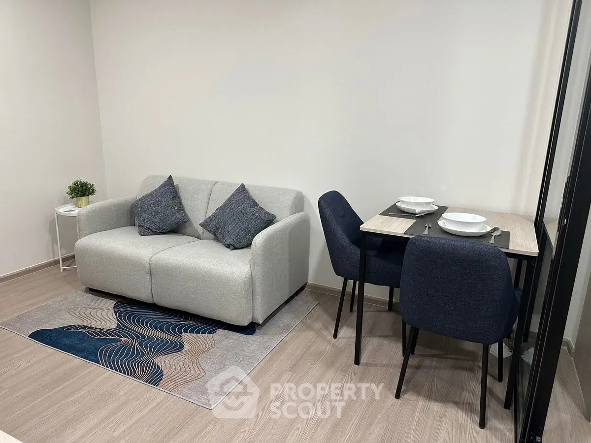 Modern living room with cozy sofa and dining area in stylish apartment.
