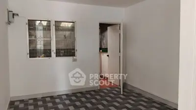 Spacious room with modern tiled flooring and window view