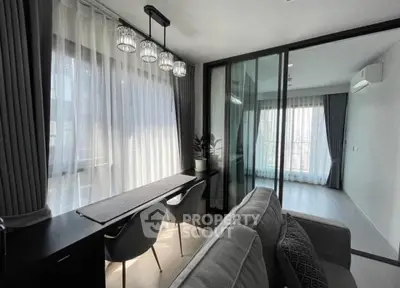 Modern living room with elegant decor and natural light in a stylish apartment.