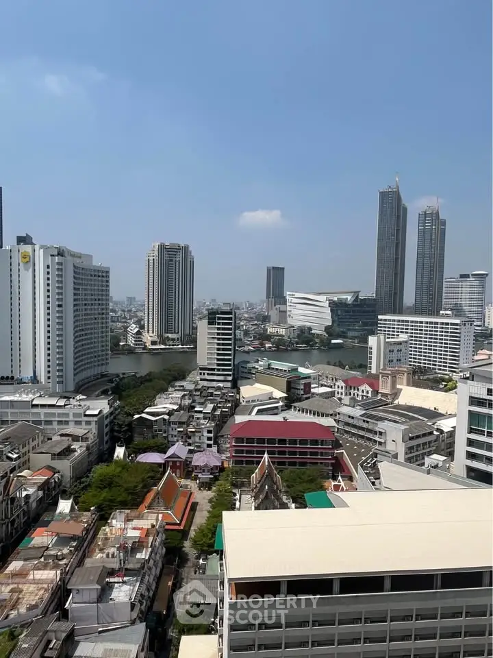 Stunning cityscape view from high-rise building showcasing urban skyline and river.