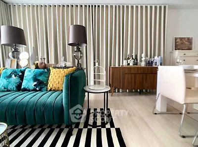 Stylish living room with modern decor and vibrant teal sofa