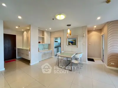 Spacious modern dining area with elegant lighting and open kitchen layout