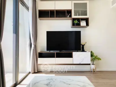 Modern living room with sleek TV unit and large windows