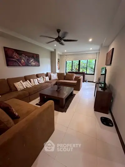 Spacious living room with large sectional sofa and modern decor, perfect for relaxation and entertainment.