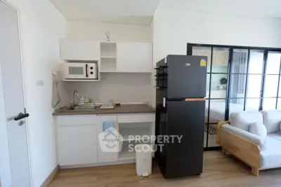 Modern compact kitchen with sleek appliances and open layout in stylish apartment