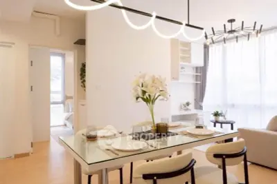 Modern dining area with elegant lighting and stylish decor in a bright open-plan living space.