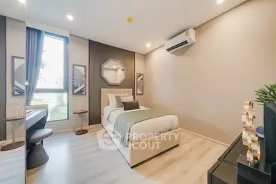 Modern bedroom with stylish decor and natural light